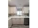Bright kitchen featuring light cabinets, double sink, and modern appliances at 215 N Power Rd # 404, Mesa, AZ 85205