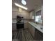 Modern kitchen with stainless steel appliances and light wood cabinets at 215 N Power Rd # 404, Mesa, AZ 85205