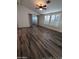 Spacious living room with wood flooring, ceiling fan, and large windows at 215 N Power Rd # 404, Mesa, AZ 85205