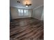 Spacious living room featuring wood-look floors and a ceiling fan at 215 N Power Rd # 404, Mesa, AZ 85205