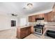 Kitchen with wood cabinets, granite counters, and stainless steel appliances at 2234 N 50Th Dr, Phoenix, AZ 85035