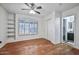 Bedroom with hardwood floors, built-in shelving, and en-suite bath at 3222 E Wickieup Ln, Phoenix, AZ 85050