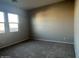 Spacious bedroom with neutral-toned carpet and large windows at 3290 W San Cristobal Rd, San Tan Valley, AZ 85144