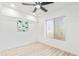 Bright bedroom with large window, ceiling fan and wood-look laminate flooring at 3350 W Wethersfield Rd, Phoenix, AZ 85029