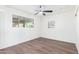 Well lit bedroom with large window, ceiling fan and wood-look laminate flooring at 3350 W Wethersfield Rd, Phoenix, AZ 85029