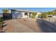 Home's exterior features a well-maintained front yard and driveway at 3350 W Wethersfield Rd, Phoenix, AZ 85029