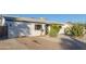 White single story home with cacti and rock landscaping at 3350 W Wethersfield Rd, Phoenix, AZ 85029