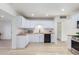 Modern kitchen with white cabinets, butcher block countertops, and stainless steel appliances at 3350 W Wethersfield Rd, Phoenix, AZ 85029