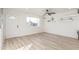 Light-filled living room showcasing neutral walls and sleek wood-look flooring at 3350 W Wethersfield Rd, Phoenix, AZ 85029
