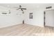 Bright and airy living room with hardwood floors and modern floating shelves at 3350 W Wethersfield Rd, Phoenix, AZ 85029