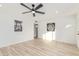 Spacious living area with hardwood floors, a ceiling fan, and decorative wall art at 3350 W Wethersfield Rd, Phoenix, AZ 85029