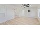 Open living room with wood-look laminate flooring, and view into kitchen at 3350 W Wethersfield Rd, Phoenix, AZ 85029