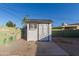 White storage shed with X-shaped double doors at 3350 W Wethersfield Rd, Phoenix, AZ 85029