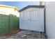 White storage shed with double doors in backyard at 3350 W Wethersfield Rd, Phoenix, AZ 85029