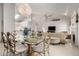 Open concept dining area with glass table and chandelier at 4524 E Villa Maria Dr, Phoenix, AZ 85032