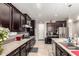 Kitchen with dark cabinetry, granite countertops and a large sink at 6260 S Fresno St, Chandler, AZ 85249