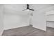 Well-lit bedroom featuring a ceiling fan, gray flooring, and a walk-in closet at 8737 S 253Rd Dr, Buckeye, AZ 85326