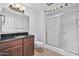 Clean bathroom with granite countertop, wood vanity, and a shower/tub combo at 9708 W Redwood Dr, Sun City, AZ 85351