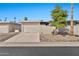 Tan colored house with a two car garage and desert landscaping at 9708 W Redwood Dr, Sun City, AZ 85351