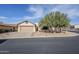 Beige, single-story home with a two-car garage and desert landscaping at 10786 E Lazy Doc Ct, Gold Canyon, AZ 85118