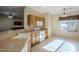 Functional kitchen with white appliances, wood cabinets, and tile flooring at 10786 E Lazy Doc Ct, Gold Canyon, AZ 85118