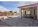 Paved patio with outdoor dining set, fire pit, and desert landscaping at 10786 E Lazy Doc Ct, Gold Canyon, AZ 85118