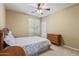 Cozy bedroom featuring a ceiling fan and floral bedding at 12121 W Patrick Ln, Sun City, AZ 85373