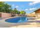 Relaxing kidney-shaped pool with surrounding landscaping at 1325 W Muirwood Dr, Phoenix, AZ 85045