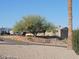 Single-story home with a large tree and RV parking at 1368 E Victoria View St, Queen Valley, AZ 85118