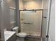 Modern bathroom with a glass shower and gray walls at 16244 N 27Th Pl, Phoenix, AZ 85032