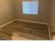 Simple bedroom with wood-look tile floor and window with blinds at 16244 N 27Th Pl, Phoenix, AZ 85032