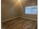 Bright bedroom featuring wood-look floors and a window at 16244 N 27Th Pl, Phoenix, AZ 85032