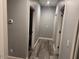 Gray hallway with wood-look flooring and access to bedrooms and bathrooms at 16244 N 27Th Pl, Phoenix, AZ 85032
