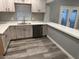 Modern kitchen with white cabinets, quartz counters, and stainless steel appliances at 16244 N 27Th Pl, Phoenix, AZ 85032
