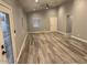 Spacious living area with wood-look tile flooring and natural light at 16244 N 27Th Pl, Phoenix, AZ 85032