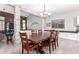 Bright dining room featuring a spacious wooden table with six chairs at 17329 W Banff Ln, Surprise, AZ 85388