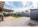 Large backyard with patio, artificial turf, and storage shed at 2161 E Gemini Dr, Tempe, AZ 85283