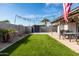 Artificial turf backyard with patio, string lights and shed at 2161 E Gemini Dr, Tempe, AZ 85283