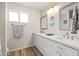 Double vanity bathroom with white cabinets and quartz countertops at 2161 E Gemini Dr, Tempe, AZ 85283