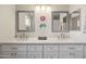 Double vanity bathroom with gray quartz countertop and mirrors at 2161 E Gemini Dr, Tempe, AZ 85283