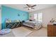 Charming bedroom with a teal accent wall and built-in shelving at 2161 E Gemini Dr, Tempe, AZ 85283