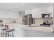 Modern kitchen with white cabinets, stainless steel appliances, and quartz countertops at 2161 E Gemini Dr, Tempe, AZ 85283