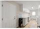 Laundry room with water cooler and white cabinets at 2161 E Gemini Dr, Tempe, AZ 85283