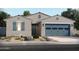 Single-story home with gray siding, blue garage door, and landscaping at 24362 W Graham Trl, Buckeye, AZ 85326