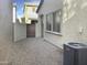 Small gravel backyard with a gate and AC unit at 2550 N 149Th Ave, Goodyear, AZ 85395
