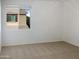 Spacious bedroom with neutral carpeting and large window at 2550 N 149Th Ave, Goodyear, AZ 85395