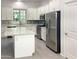 Modern kitchen with white cabinets, stainless steel appliances, and an island at 2550 N 149Th Ave, Goodyear, AZ 85395
