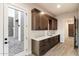 Laundry room features wood cabinets, quartz countertops, and a built-in sink at 256 E Tumbleweed Dr, Phoenix, AZ 85085