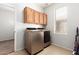 Bright laundry room, featuring washer, dryer, and ample cabinetry at 25719 W Victory St, Buckeye, AZ 85326