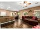 Open living space with a brown sectional and kitchen views at 282 E Dry Creek Rd, San Tan Valley, AZ 85143